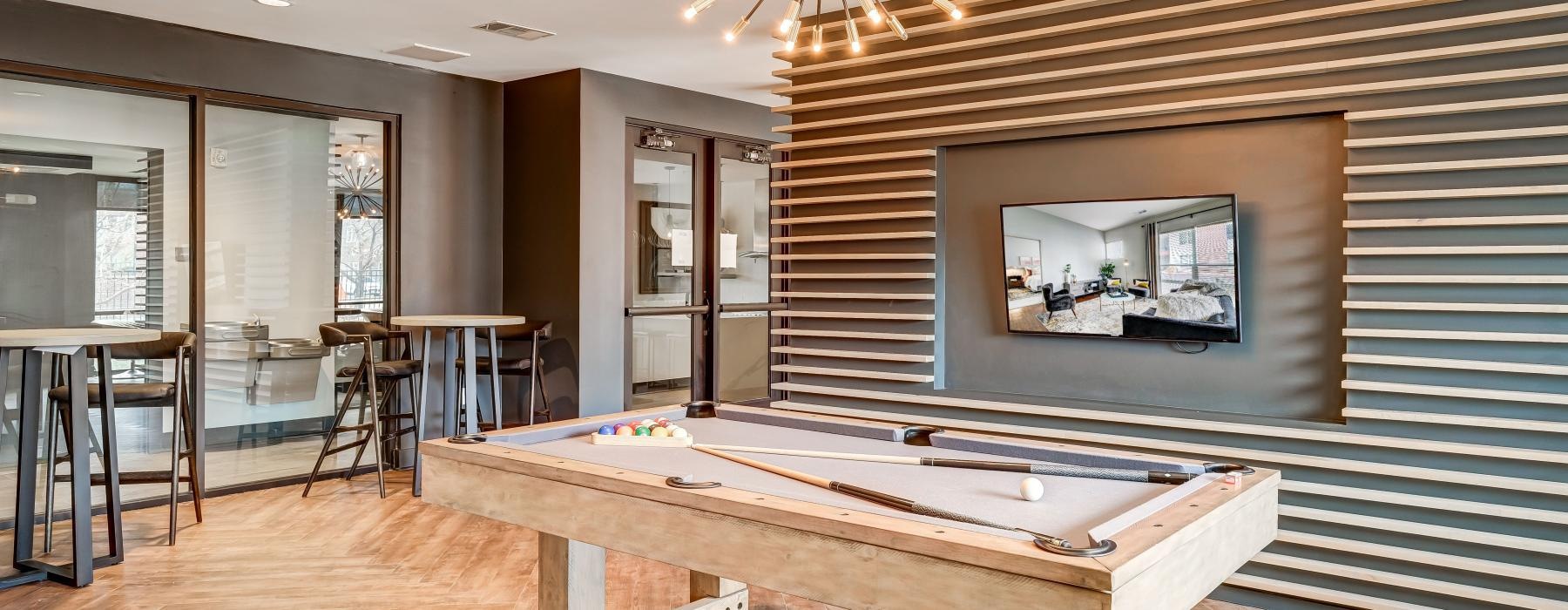 a room with a pool table and a chandelier